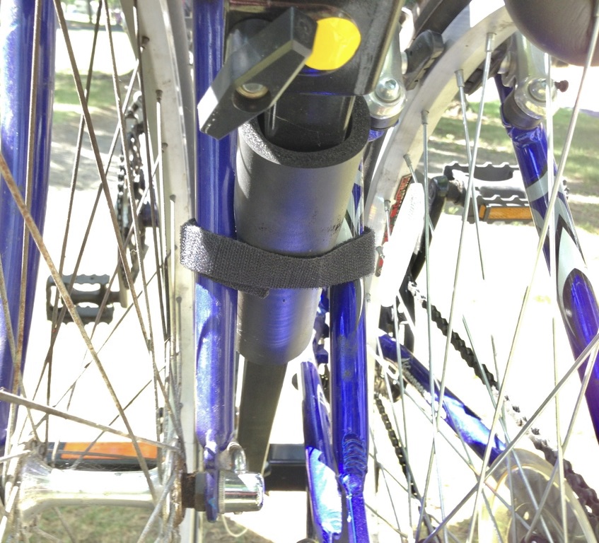 Velcro straps securing bike frames to rack frame.